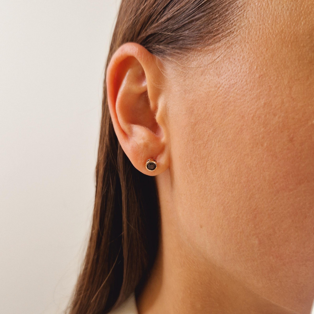 Gold earrings with a black diamond